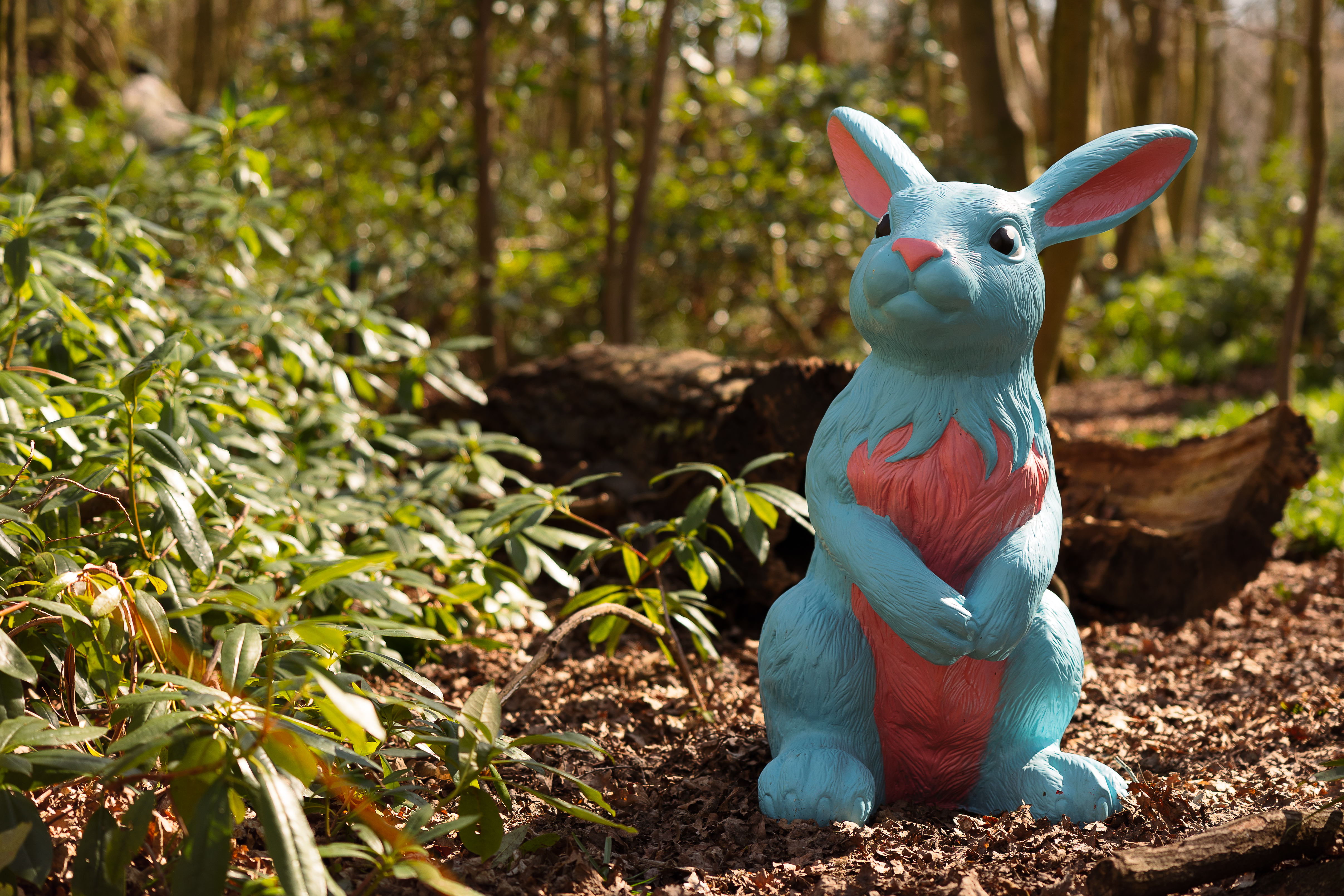 blue and pink rabbit ornament in forest
