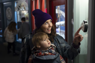 woman and boy interacting with game