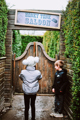 boy and girl opening saloon door in a maze