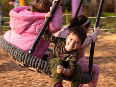 Child smiling on the unicorn swing