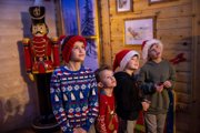 Four children in Santa hats in Santa's Grotto
