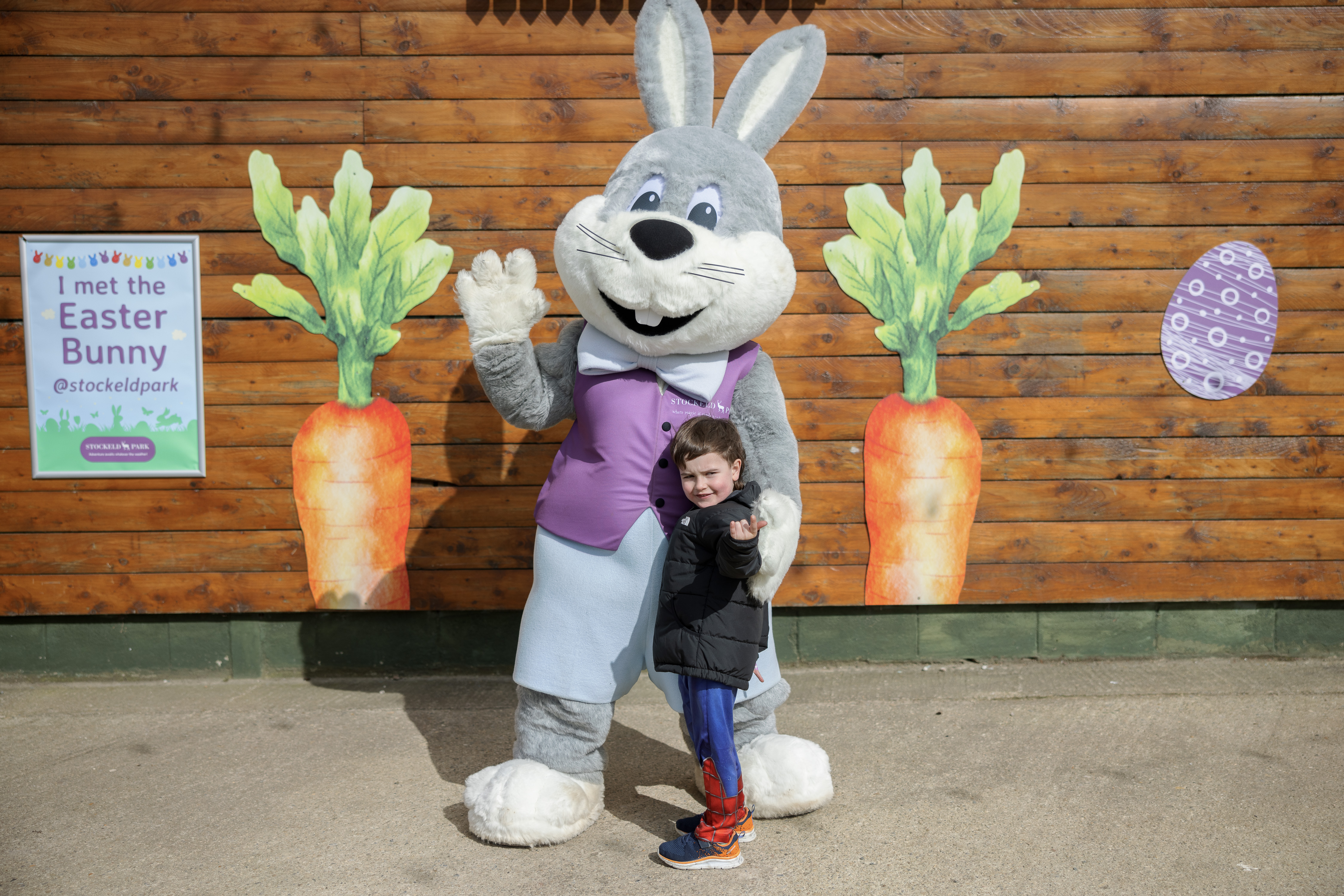Easter Bunny Waving With Little Boy In Spiderman Costume