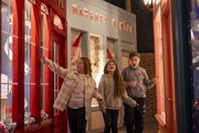 3 Kids walking down North Pole Street in the Grotto while smiling
