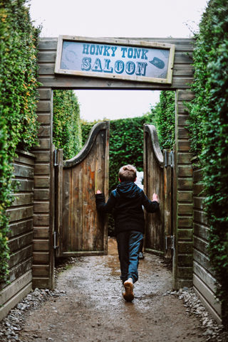 boy and girl going through door in a maze