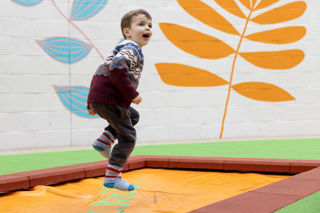 boy jumping on trampoline indoor play centre