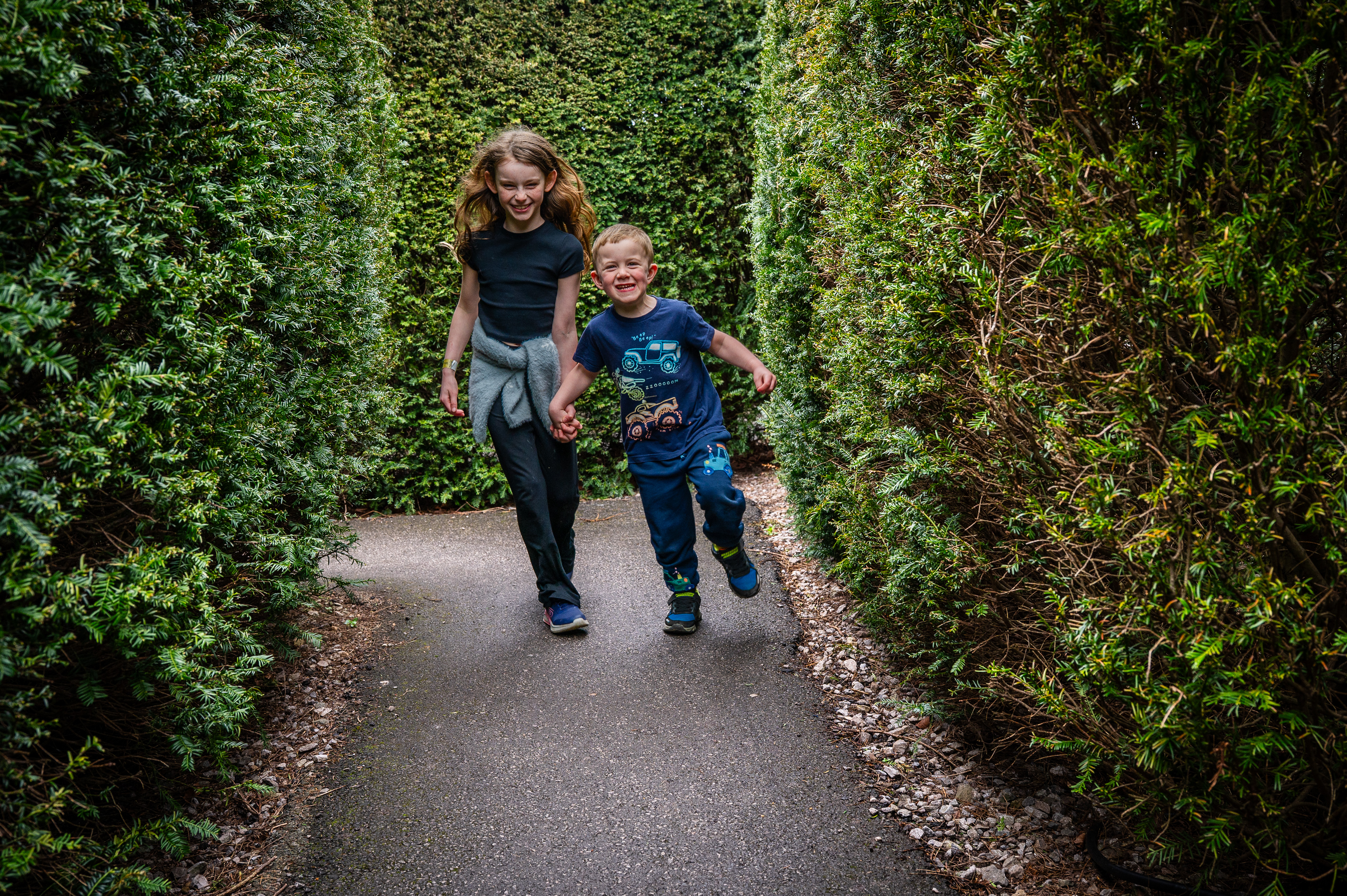 DC Easter 2026 Girl And Boy Wearing Blue Running Through Maze Hedges (1)