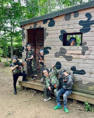 blue team posing at their base for a picture