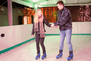 A couple on a date ice skating