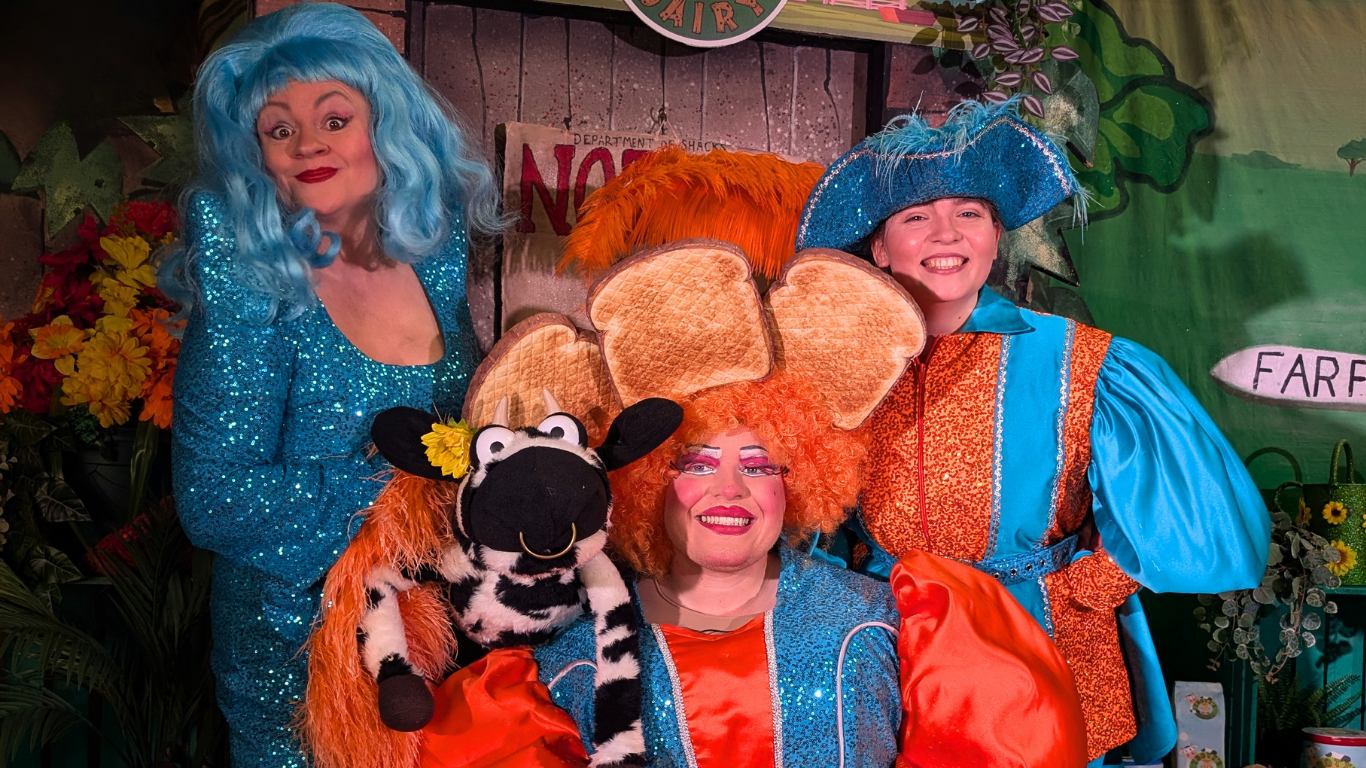3 Pantomime Characters And A Cow Puppet On Stage