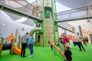 Parents and children in an indoor play area at Stockeld Park.