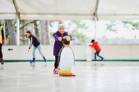 girl ice skating with penguin skate aid