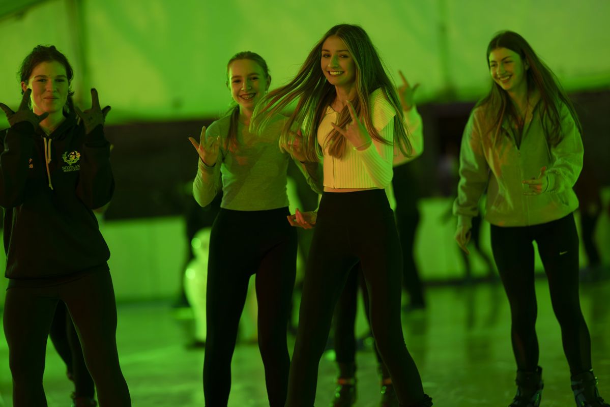 A group of girls ice skating