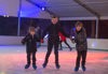 3 boys holding hands ice skating