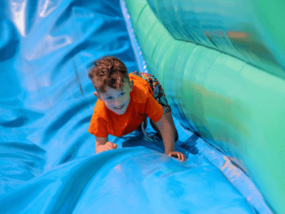 Boy sliding down the giant slide