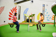 Central Zone in the playhive two adults playing on the seesaw