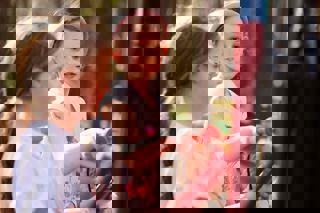 Two girls playing with the chimes at the fairy village