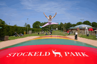 A girl jumping on the giant pillow