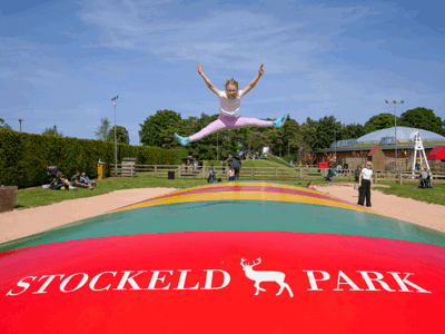A girl jumping on the giant pillow