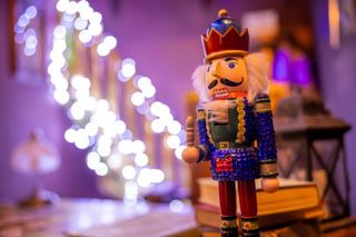 A nutcracker in front of fairylights