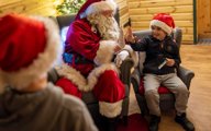 Santa playing with children in grotto