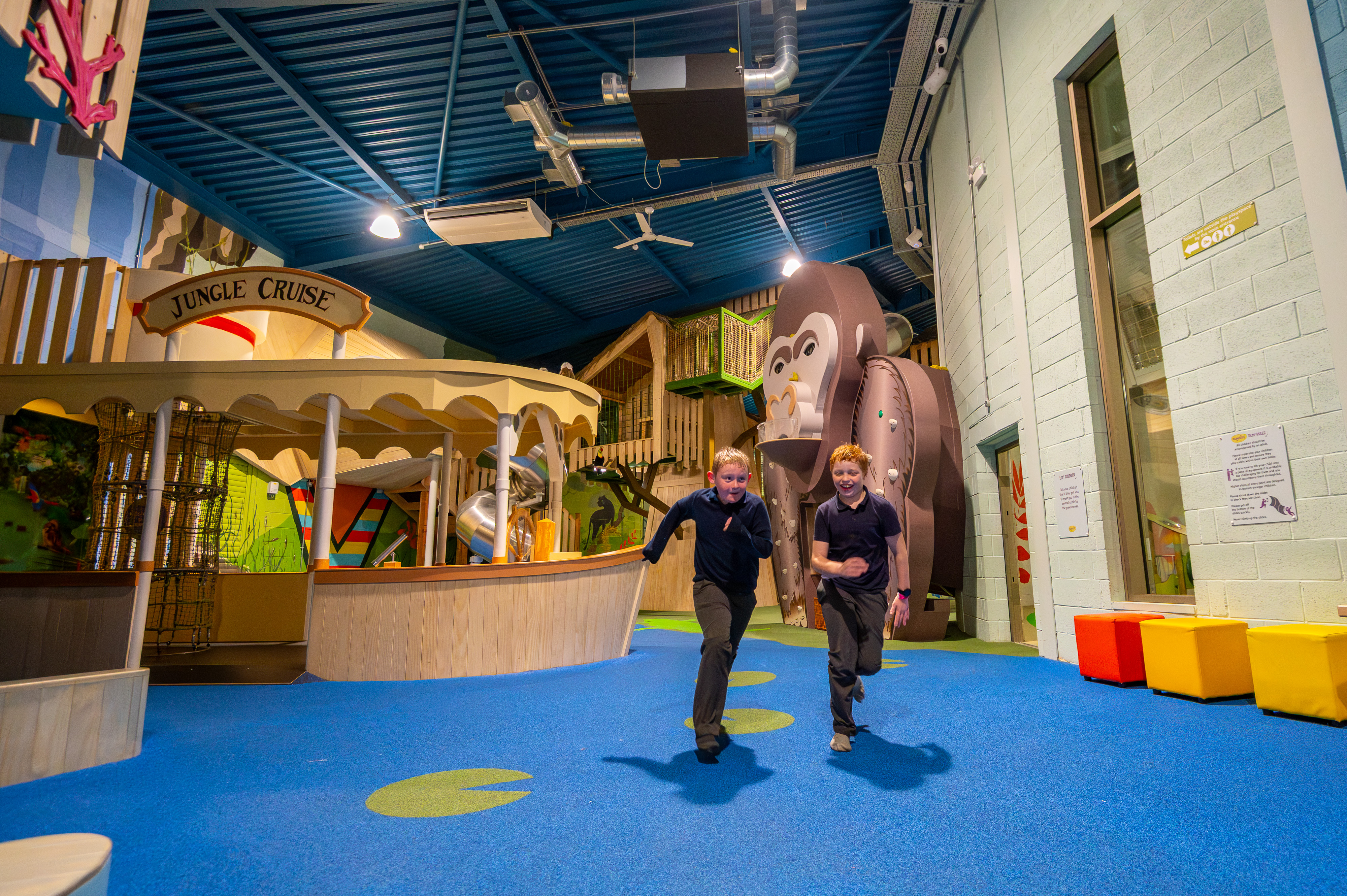 2 boys running through jungle section in the playhive