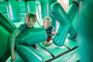 2 boys in the inflatable assault course