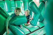 2 boys in the inflatable assault course