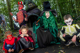 Group of 4 kids with a witch at the witches hat