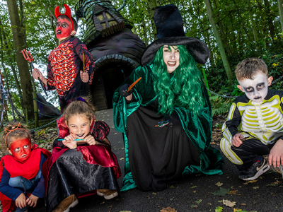 Group of 4 kids with a witch at the witches hat