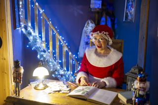 Mrs Claus sat at her desk smiling