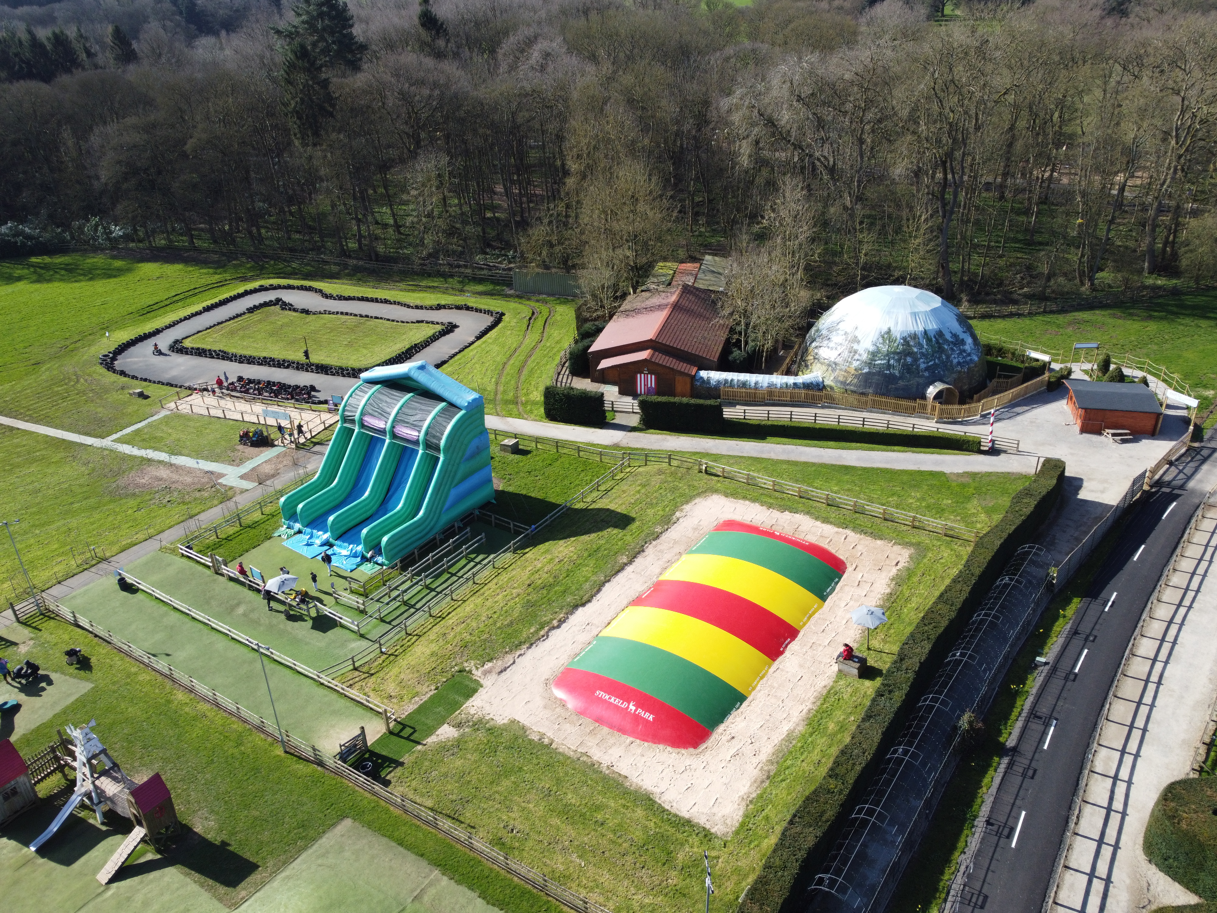 drone image of brightly coloured inflatables in park