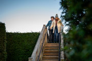 couple walking down stairs on a bridge in a maze