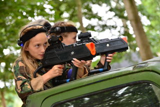 girl and boy in camo playing laser tag holding laser guns