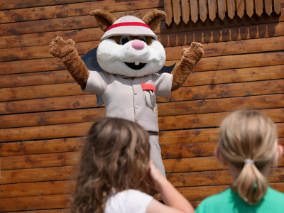 scout the squirrel mascot on stage waving
