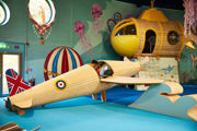 a mum and child playing in the seaplane in the playhive with a yellow submarine in the background