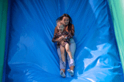 Close up of a mum and daughter sliding down the slide