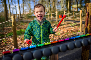 young boy playing xylophone at stockeld park