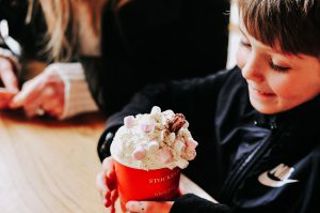 Young boy drinking hot chocolate