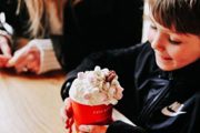 Young boy drinking hot chocolate