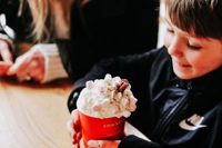 Young boy drinking hot chocolate