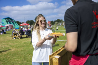 woman being served hot dog