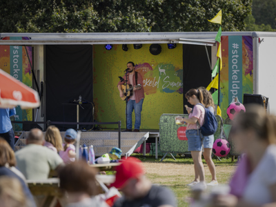 singer on festival stage playing guitar
