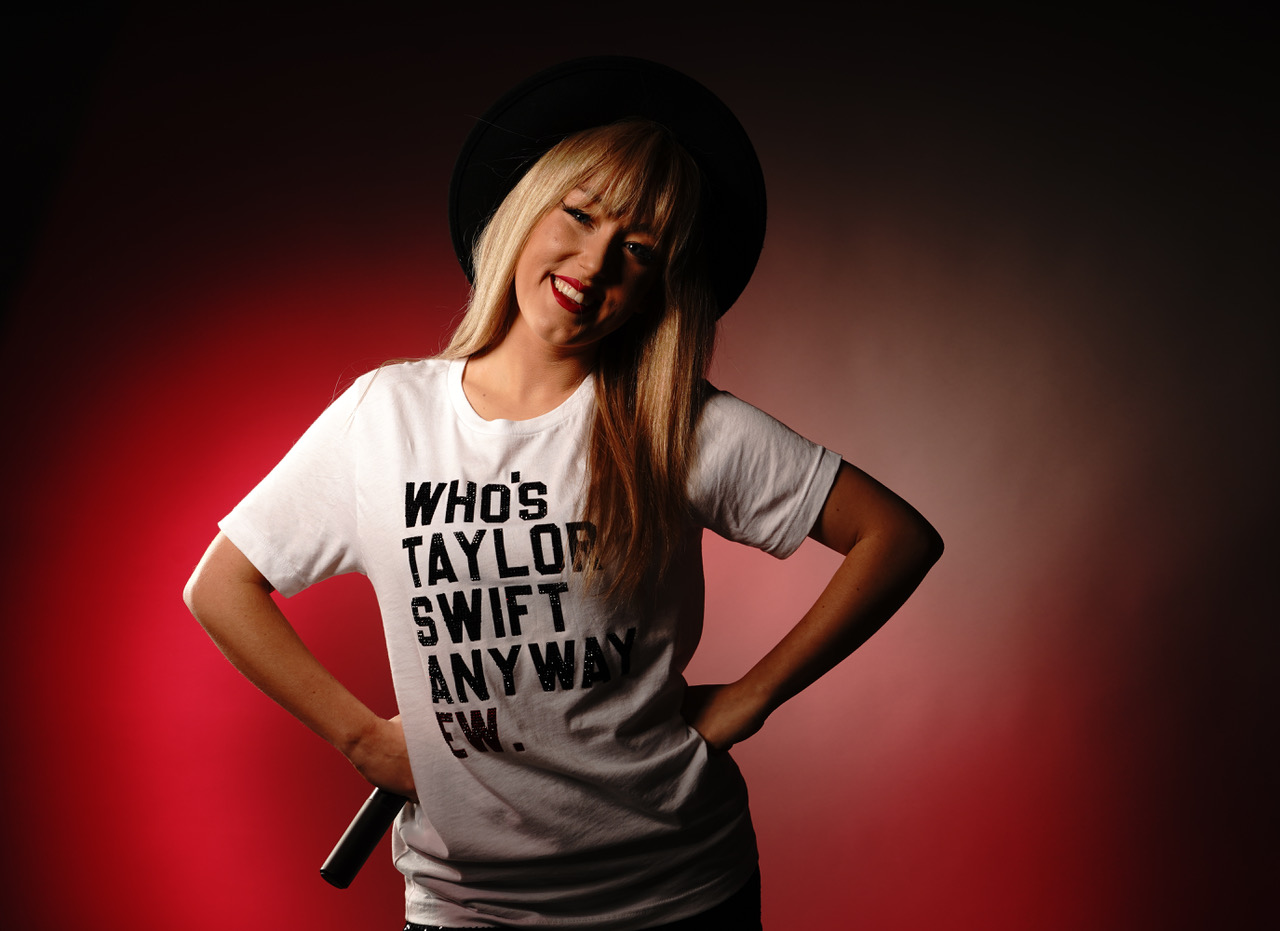 woman dressed as taylor swift with hat and white tshirt