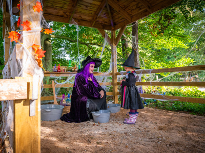 Witch with purple hair Talking To Girl In Witch Costume