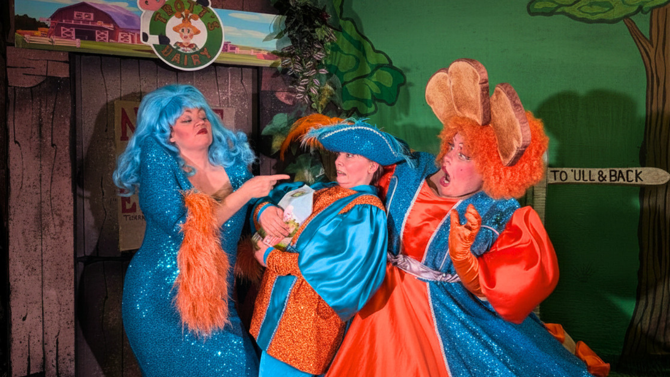 Three Theatre Characters Dressed In Blue And Orange Costumes On Stage