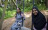 Two women playing on the swing in Tangle Tree Climb
