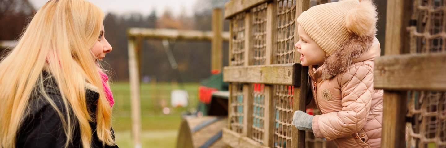 young child and mother in outdoor play area at stockeld park