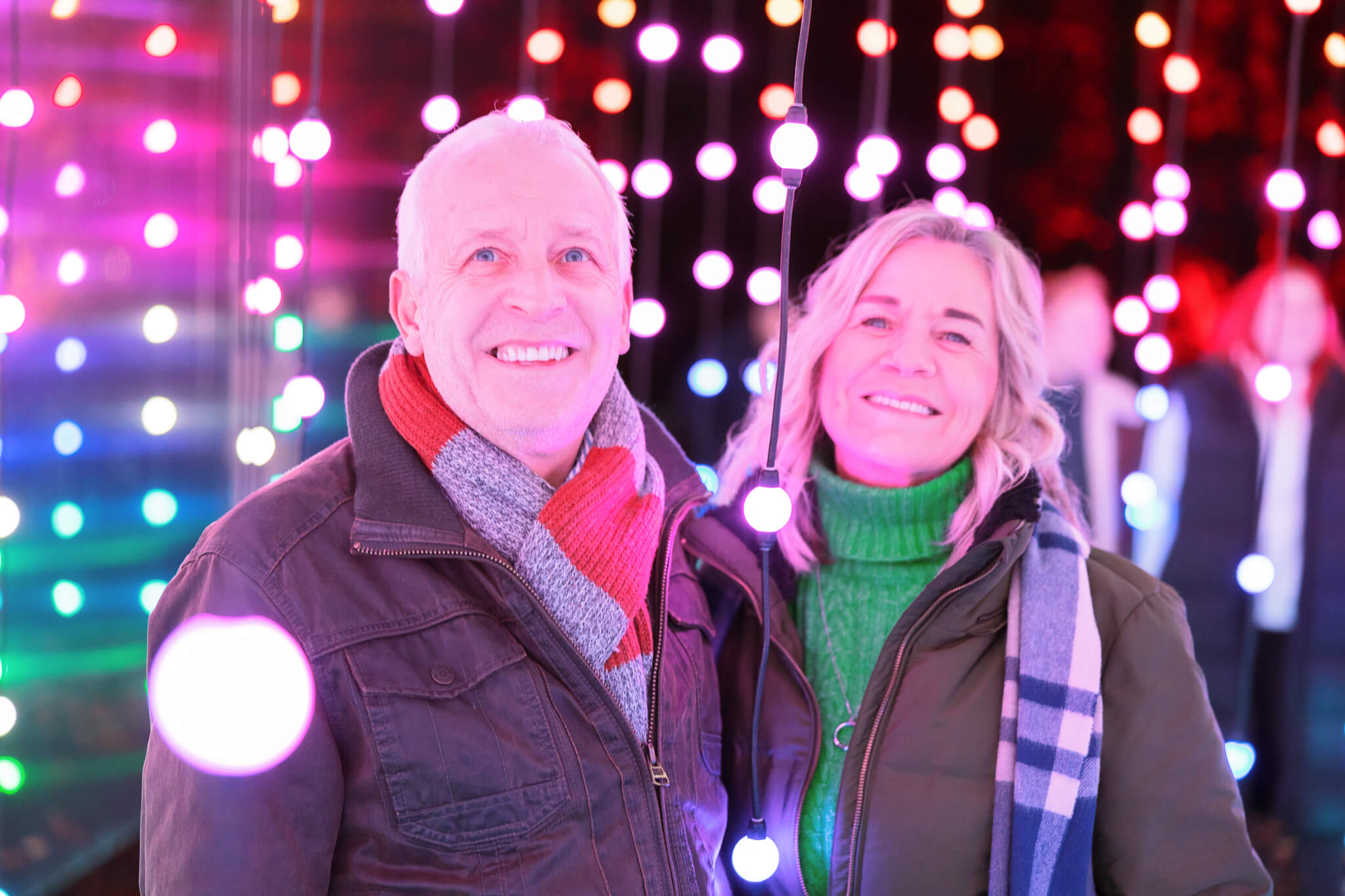 Mature couple walking through illuminated lights