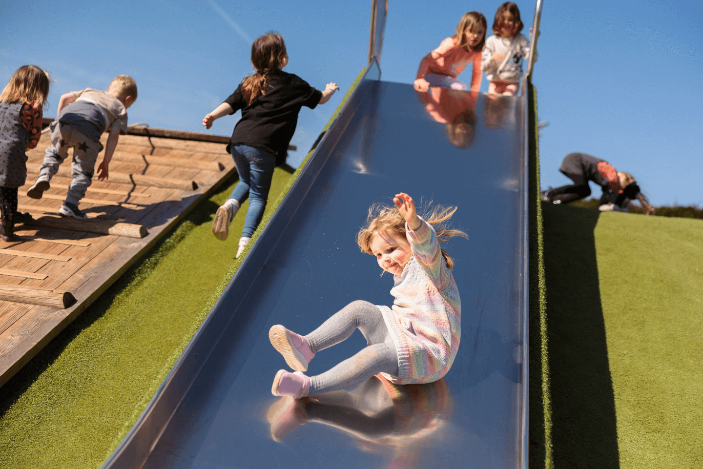 Young girl on a slide in Stockeld Park