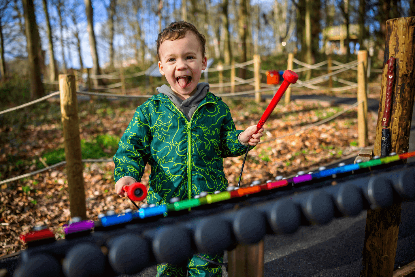 Young child happily playing in Stockeld Park's outdoor playgrounds